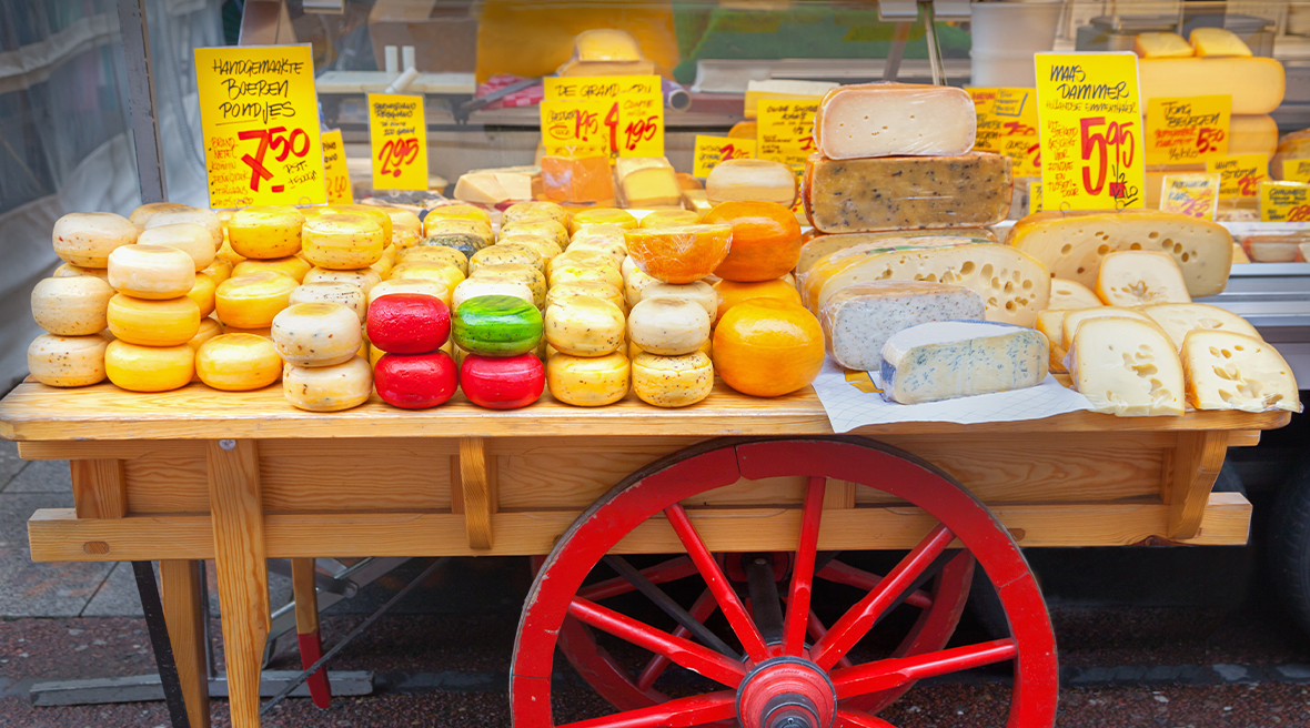 Dutch cheese on top of a table with a wheel in a market
